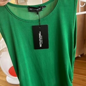 Green body-con dress. Form fitting. Seems small for a 10.